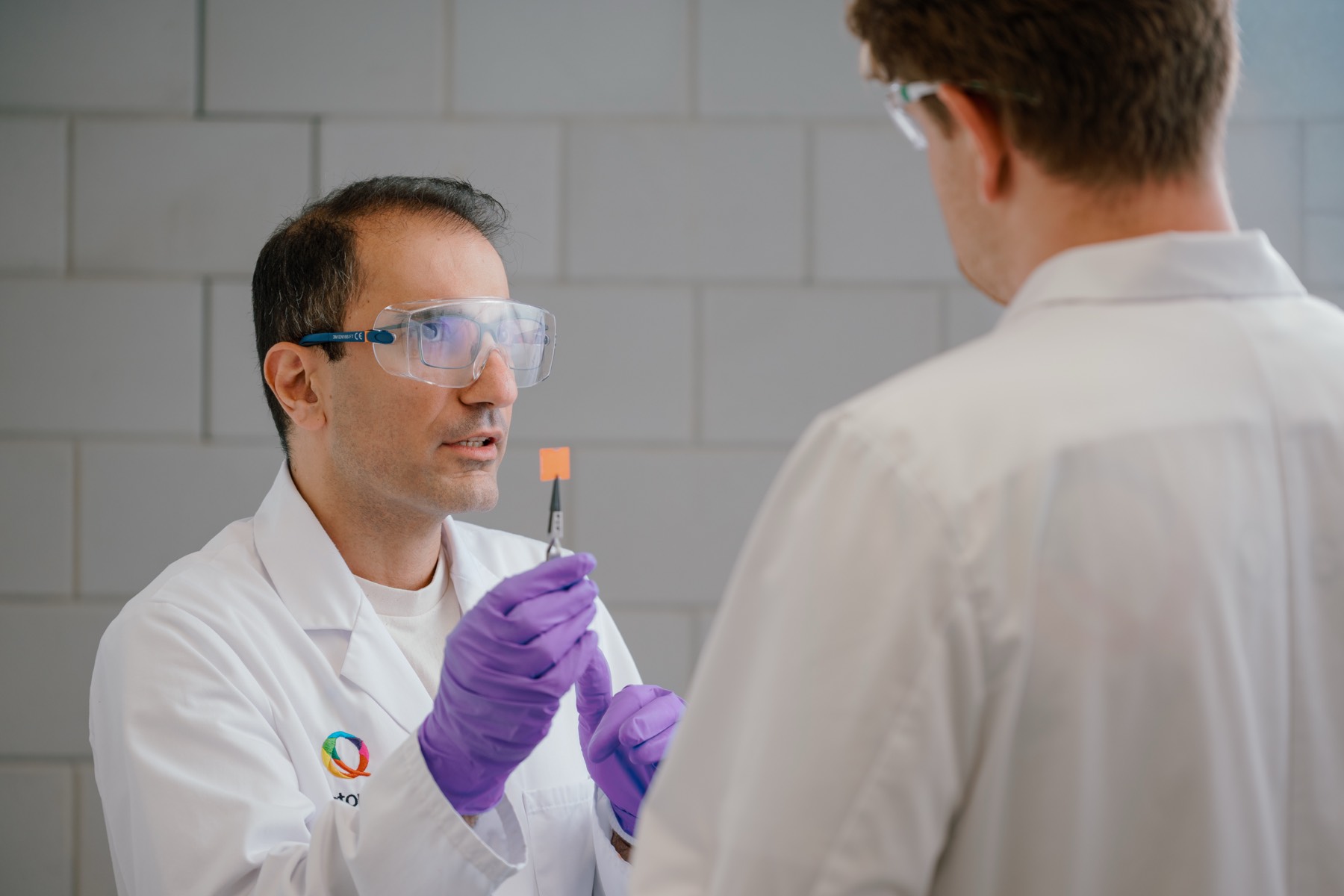 Scientists examining a QustomJet™ colour-conversion sample